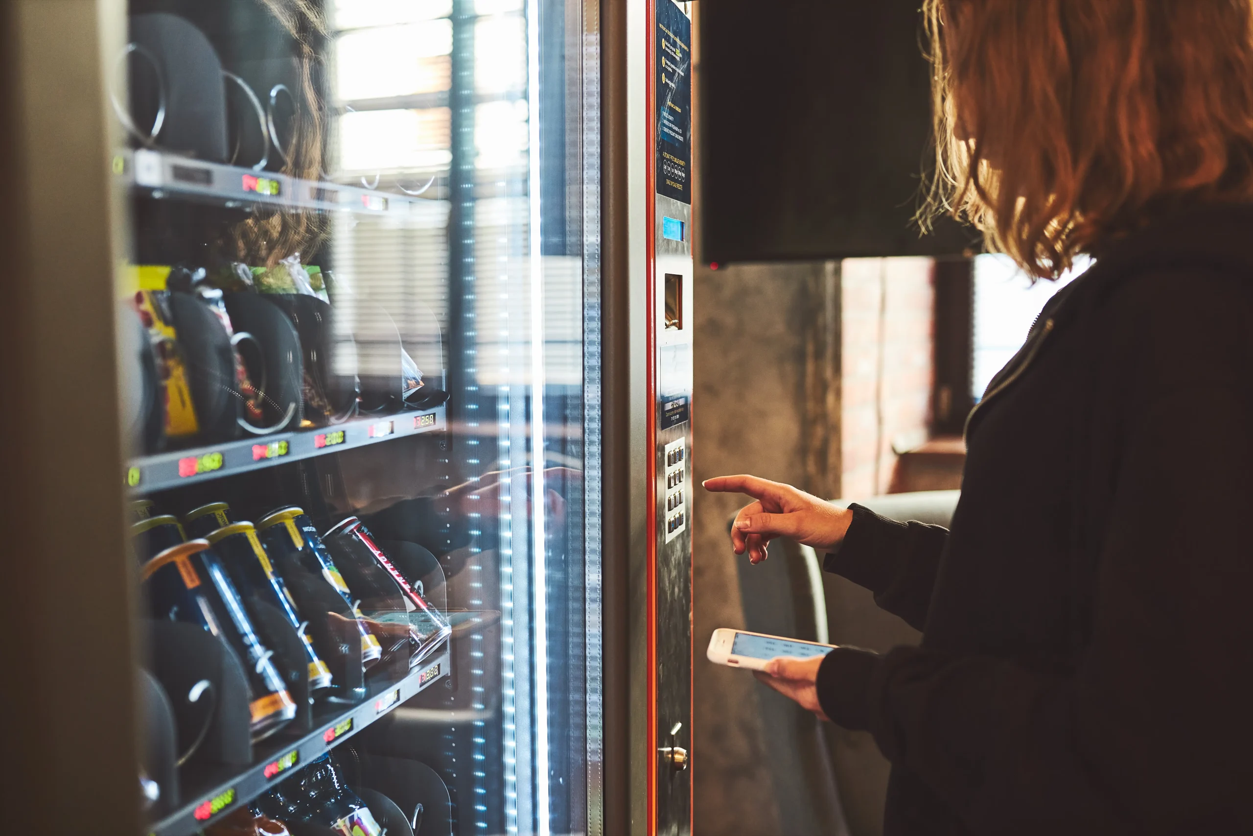 woman-paying-product-vending-machine-using-contactless-method-payment-with-mobile-phone